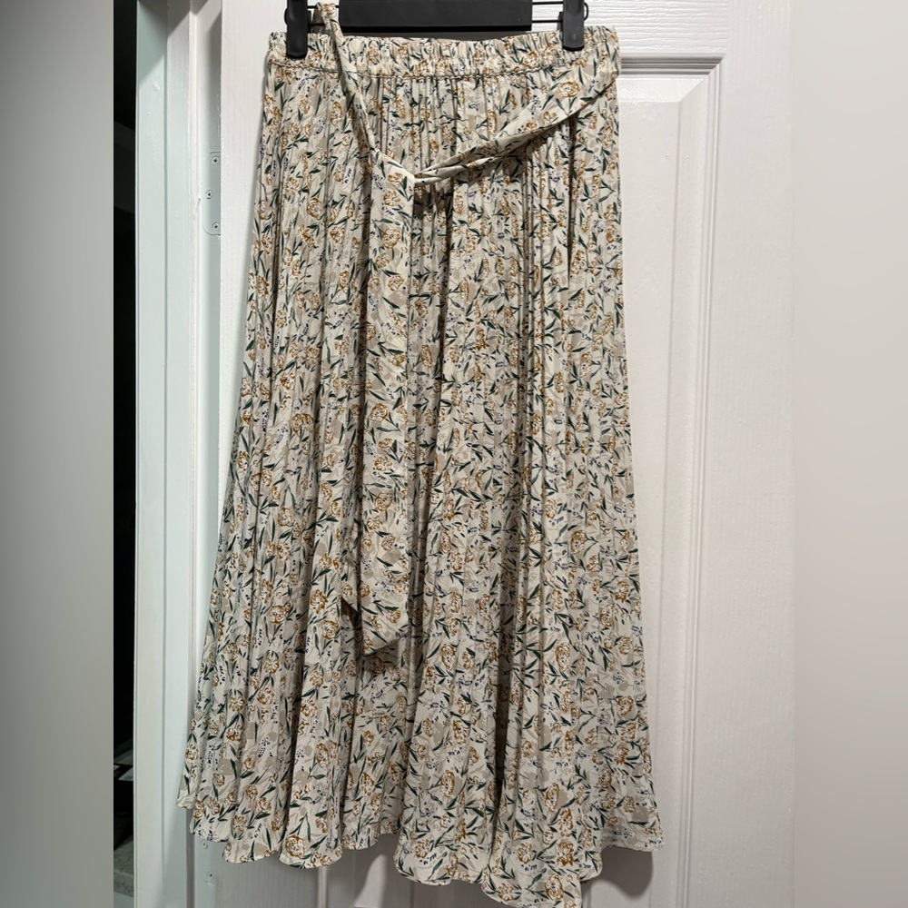 Skies are blue, high waisted flowy skirt with yellow green white coloring